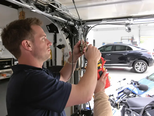 Whitehall Garage Door Repair safety certified technician performing cable replacement in Whitehall